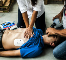 man having a heart attack undergoing CPR