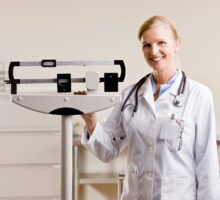 doctor in white coat displays doctors' scales