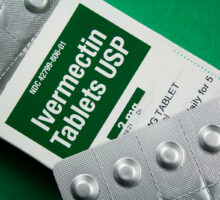 Green and white box of ivermectin tablets labeled in English