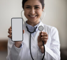 Cardiologist with cellphone and stethoscope discusses CAC scores
